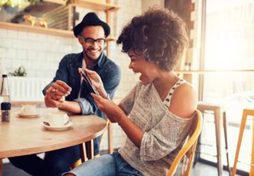 Two people enjoying a coffee at the cafe.