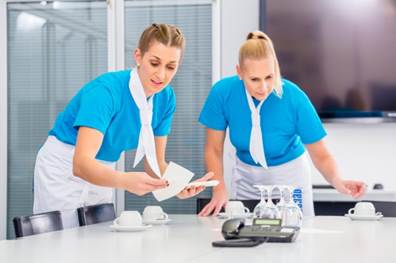 Two waiters setting up a table.