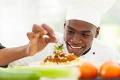 A chef  finishing to plate up a meal