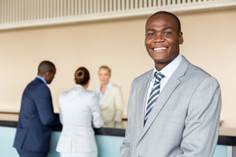 A manager standing in the lobby of a hotel