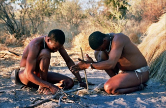 Two indigenous people preparing a fire